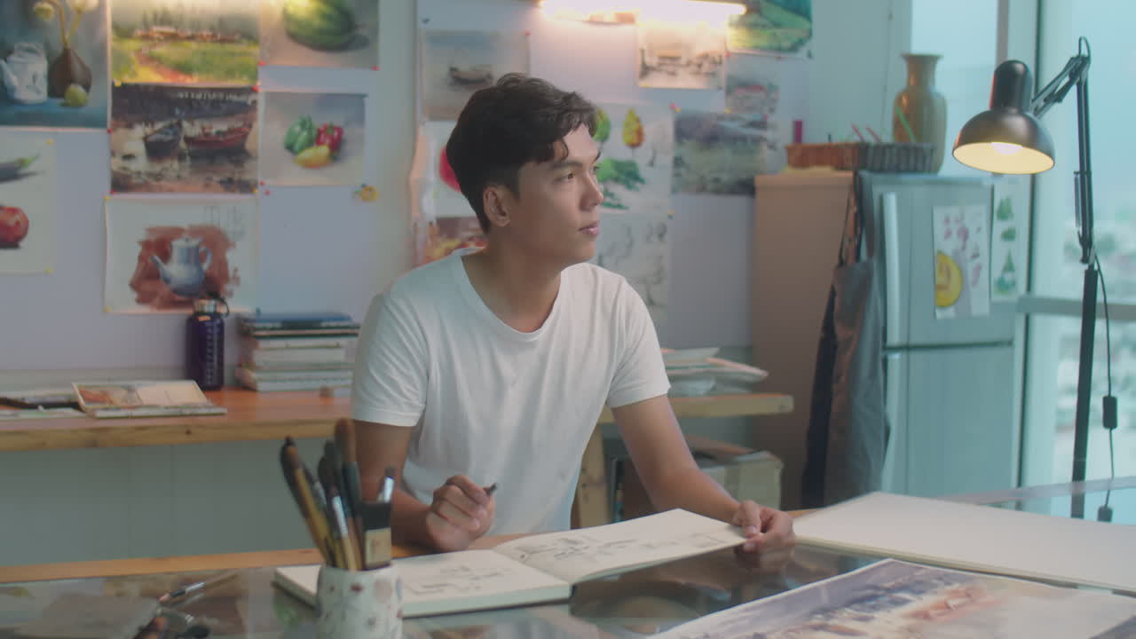 Asian Artist Drawing with Wax Crayon in Creative Studio