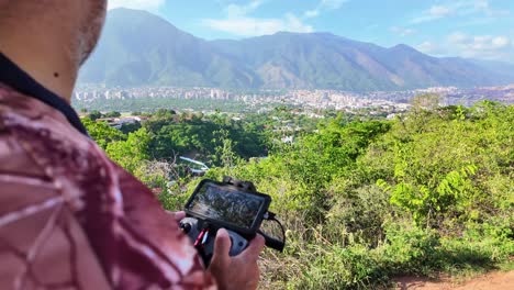 nature scene from a vantage point overlooking the city. caracas city stretches out mid-ground and prominent cerro el ávila or el ávila national park forming a natural backdrop