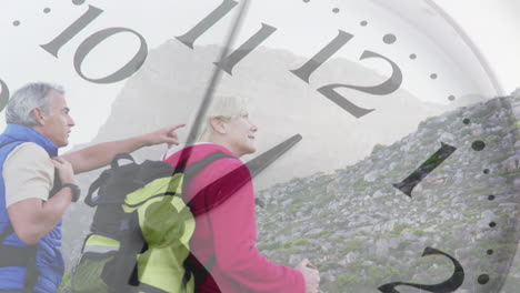 happy caucasian senior couple hiking in mountains over spinning clock