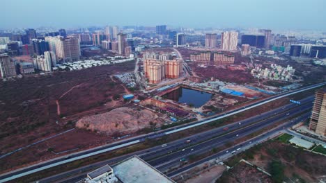pacifica hillcrest apartments with crowded buildings and empty land at financial district, nanakramguda, hyderabad, telangana, india. day time, semi orbit, drone shot, 4k.