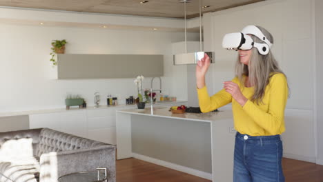 using vr headset, woman interacting with virtual environment in modern kitchen, at home, copy space