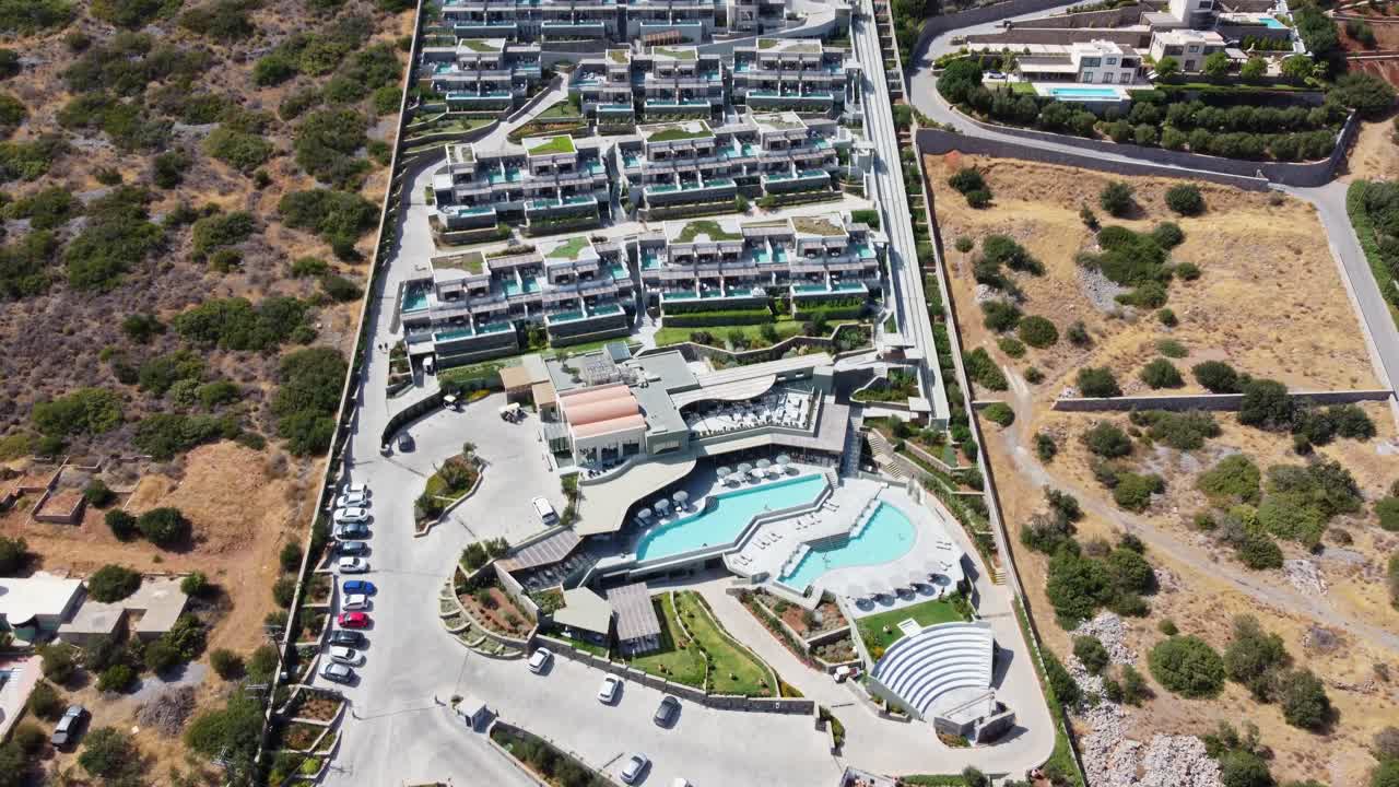 그리스 크레타의 카이오 리조트의 전망 - 드론이 날아다니는 리조트 위의 새의 시야 - 집과 많은 테라스 수영장이 볼 수 있습니다.