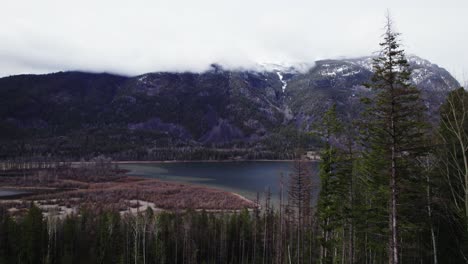 Hovering-over-Wintry-Mountains-and-Pine-Trees-on-a-Cloudy-Day-during-the-Late-Afternoon-at-St