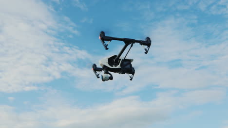 copter or drone flies against the blue sky