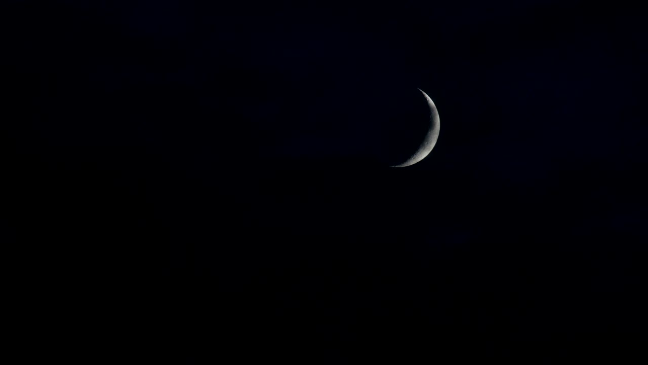 Crescent Moon With Clouds That Are Blown By The Wind During A Storm At Night Clouds Float Past The Moon. On The Surface, You Can See Details Of The Moon