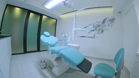 modern dental practice. dental chair and other accessories used by dentists in blue, medic light. fisheye