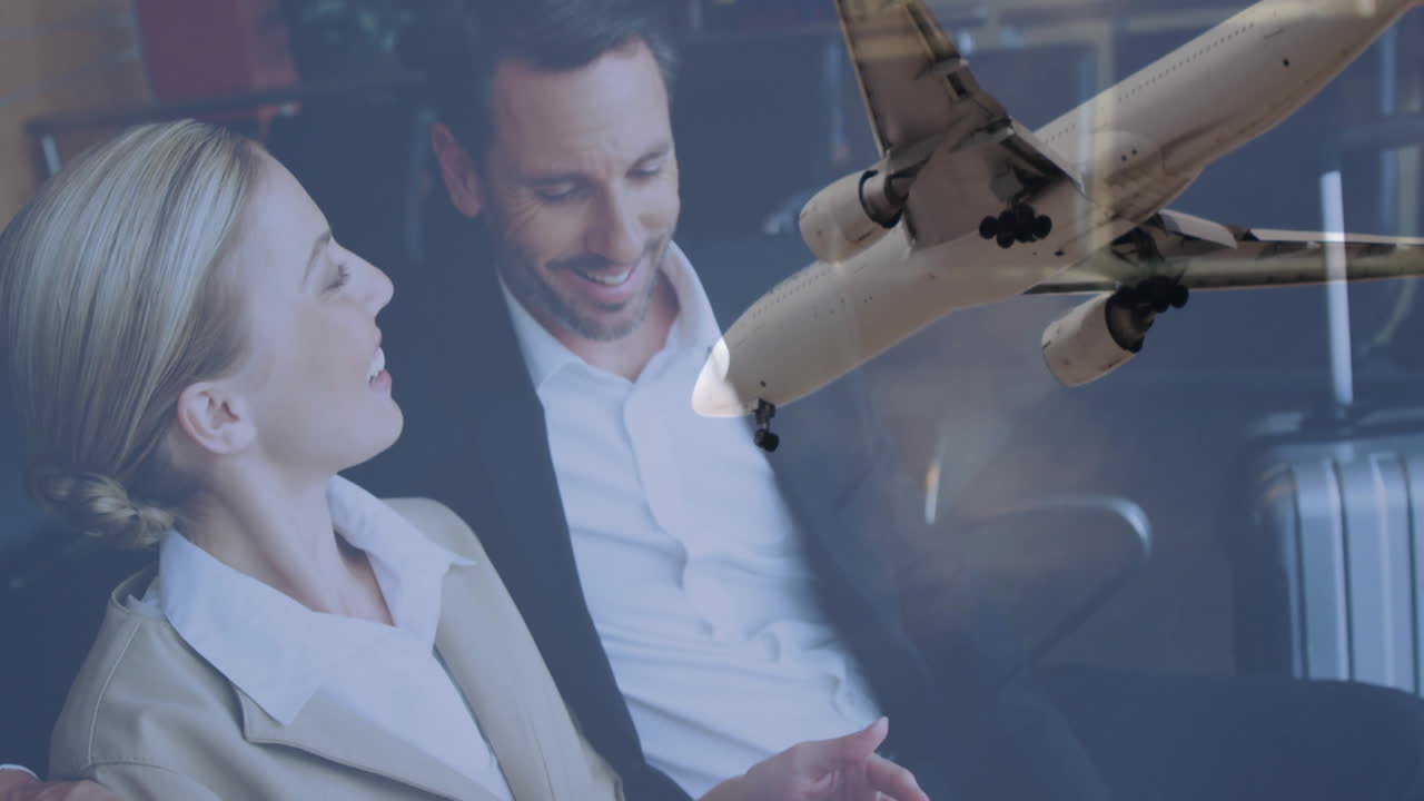 Conversing business professionals with airplane flying overhead, smiling and engaged
