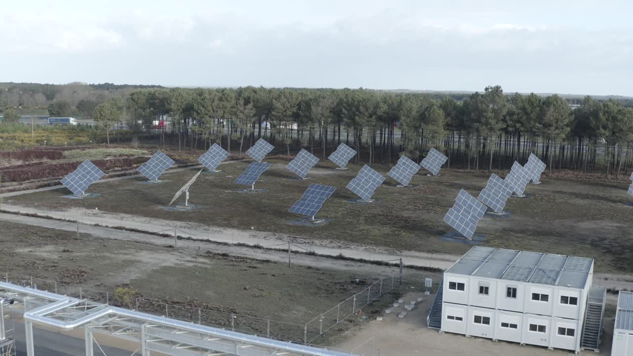 Aerial view of solar panels generating renewable energy at factory site, industrial infrastructure visible, Castets, France