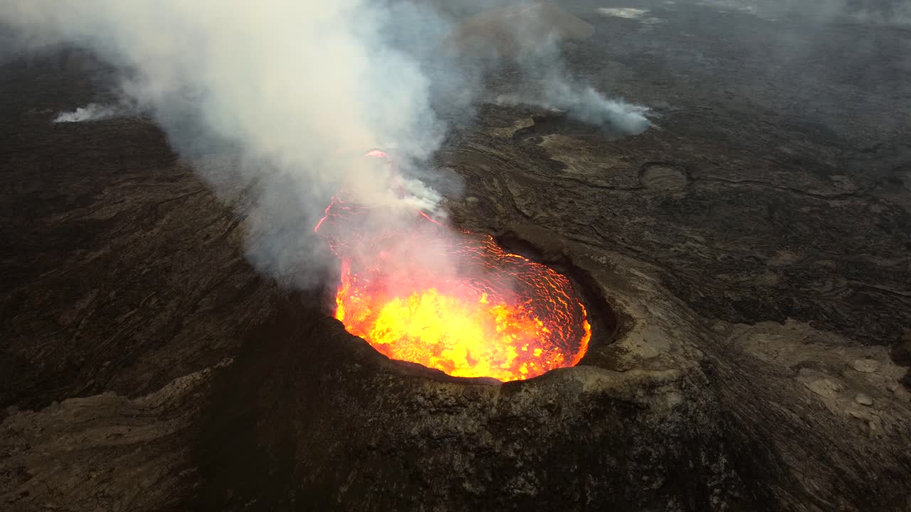 Aerial footage from Fagradallsfjall vulcano in Iceland, the lava is heavily bubbling in the crater