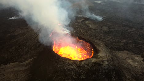 aerial footage from fagradallsfjall vulcano in iceland, the lava is heavily bubbling in the crater