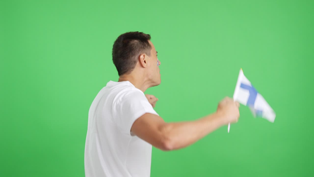 Rear view of a man waving a finnish pennant