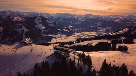 Snowy-mountains-in-low-clouds-and-blue-sky-at-sunset-in-winter