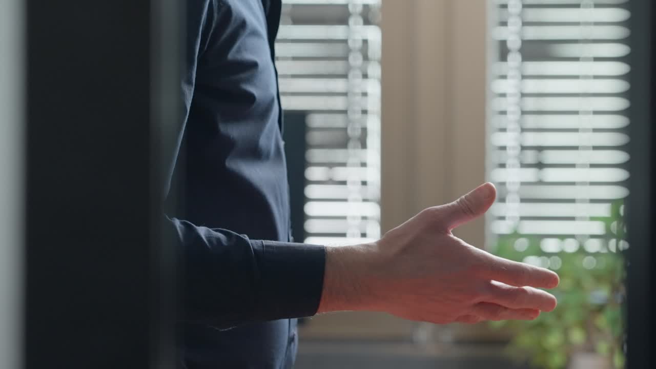 Two men exchange secret document files in yellow folder inside corporate office. Mysterious shady suspicious deal indoors. Passing government intelligence and confidential information and shake hands