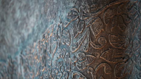 Close-up shot of a wall with flower texture, brown and silver, with depth of field