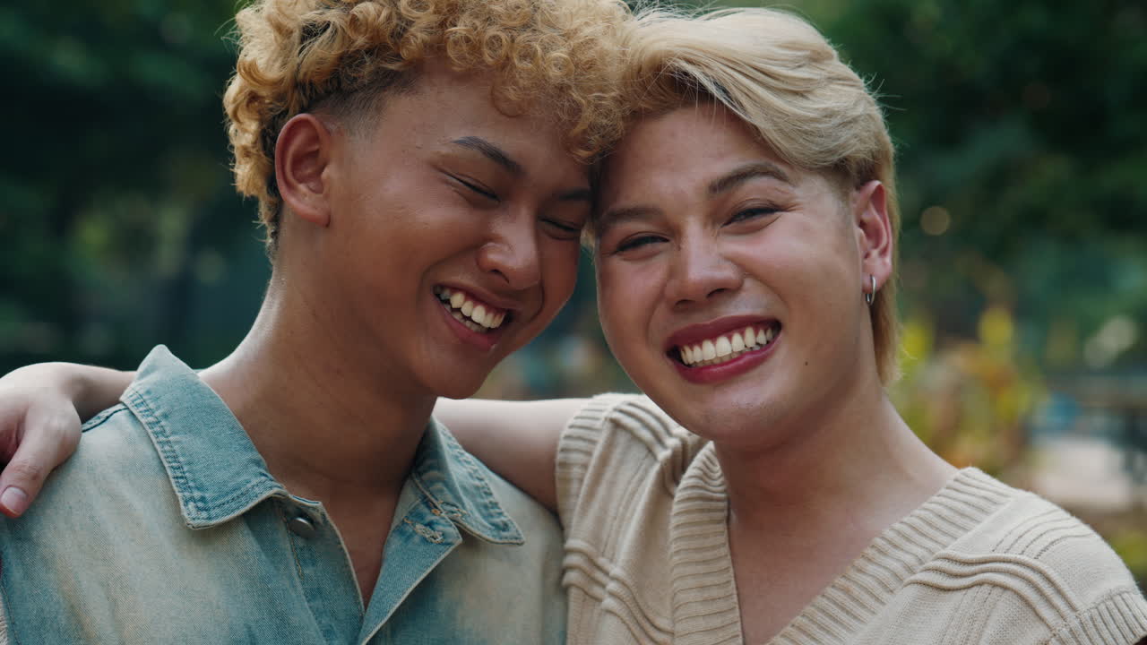 Affectionate gay couple embracing and smiling