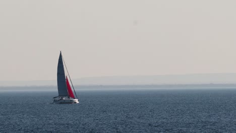 sailboat gliding across calm ocean waters