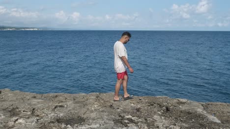 man walking seashore