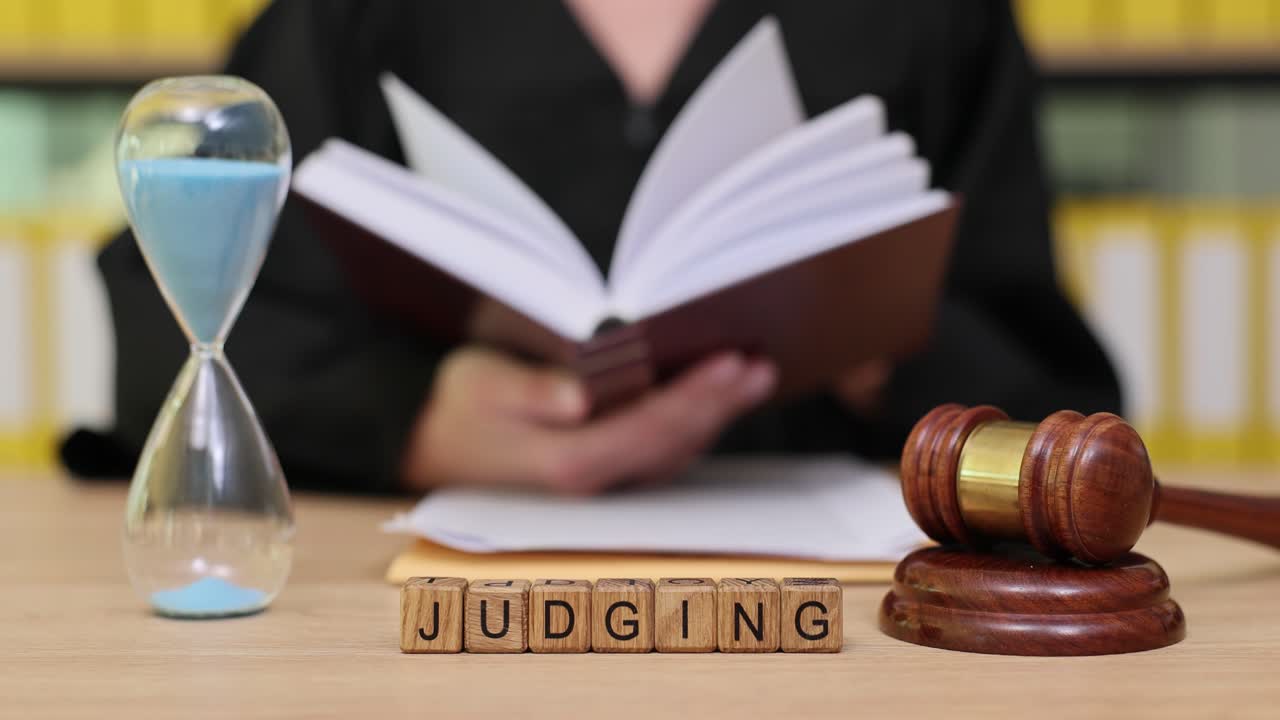 Judging with Gavel, Hourglass, and Book