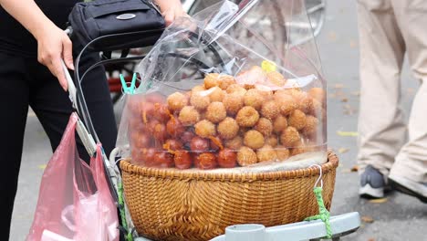 vendor pushing cart with snacks in hanoi