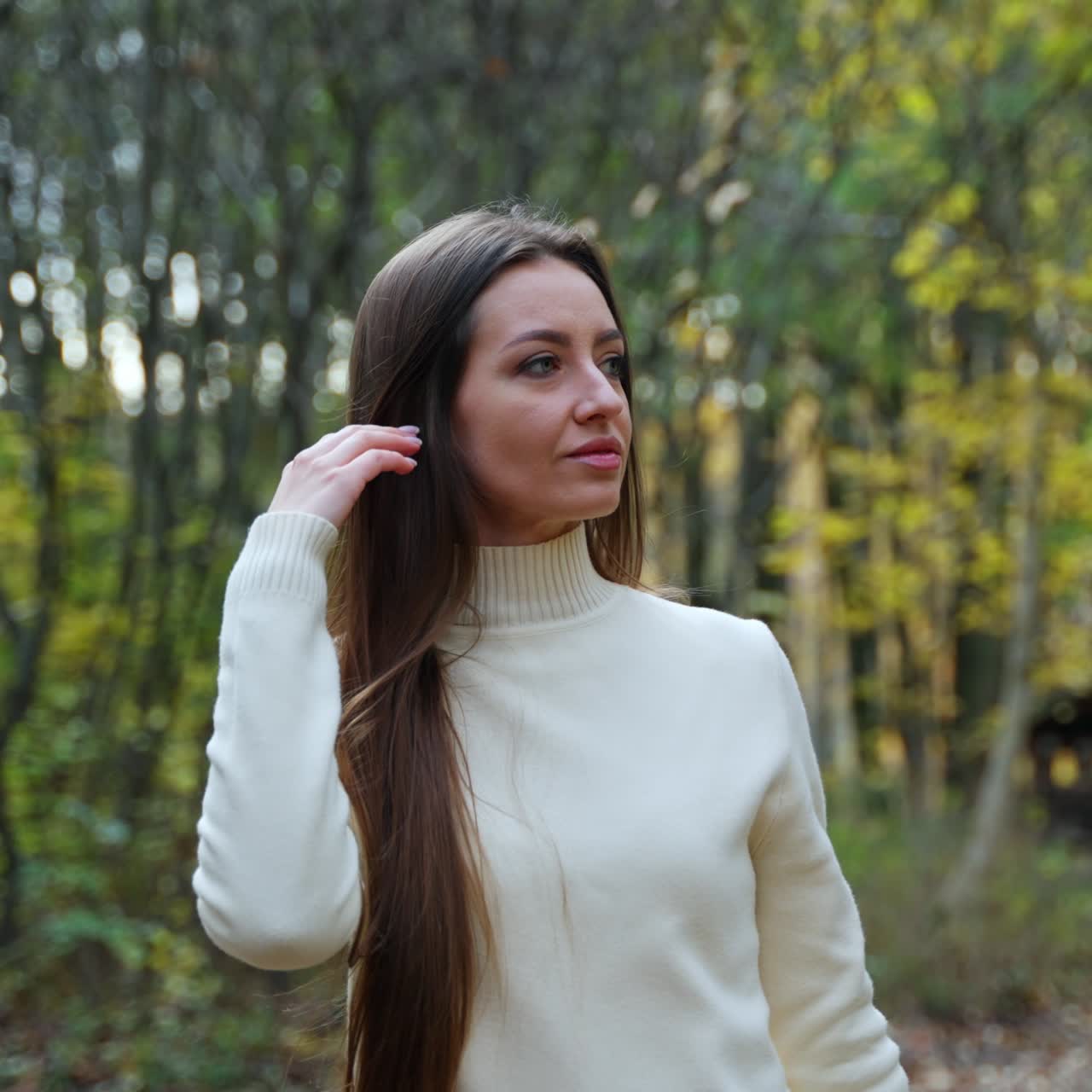 Young pretty woman walking in autumn forest. Portrait of cute lady walking in park