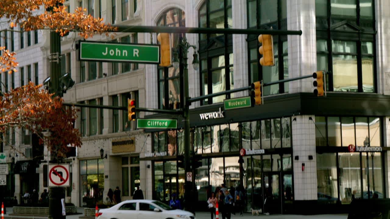 Vehicles along Woodward Avenue and John R in downtown Detroit, Michigan with video tilting down.