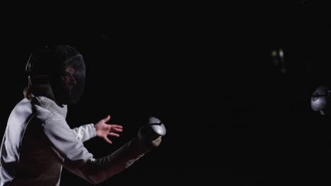 a fencer in action with a foil, dark background