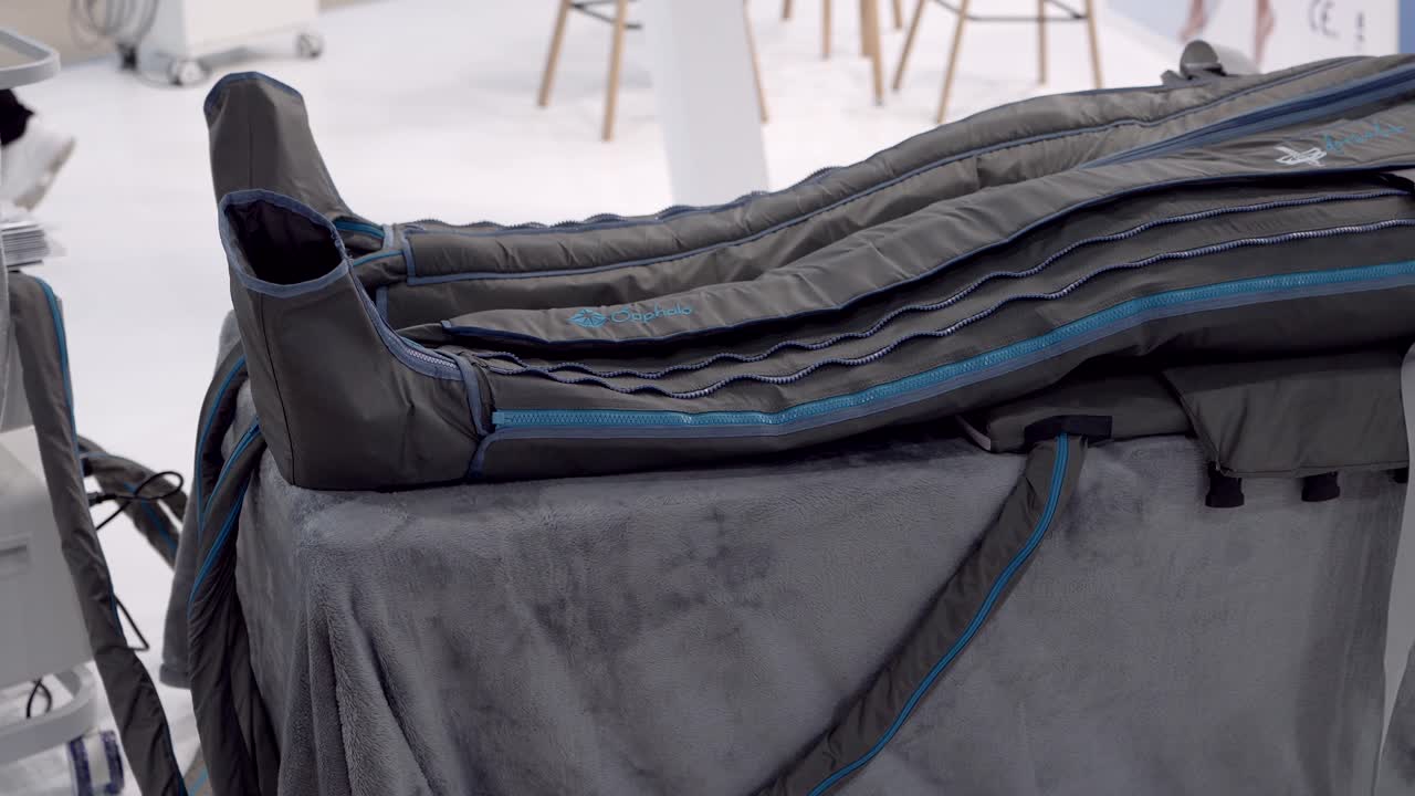 Inflatable leg compression garment displayed on padded table in clinic