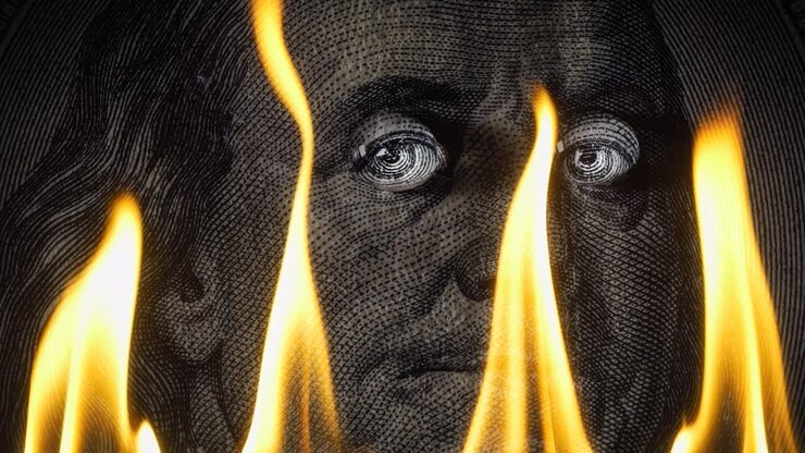Portrait of Benjamin Franklin on a hundred dollar bill on fire in flames. Conceptual 4k slow motion video. The idea of a financial crisis.