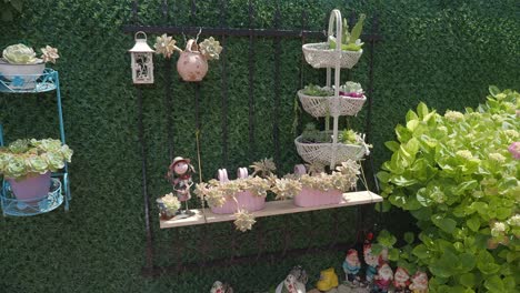 decorated garden wall with succulents and ornaments