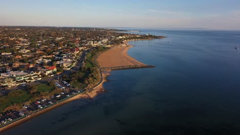 drone footage flying along the beach of brighton in melbourne, australia