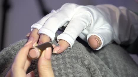 Close-up-Of-a-Woman's-Hands-Carefully-Applying-Nail-Polish-To-Her-Own-Nails-At-Home