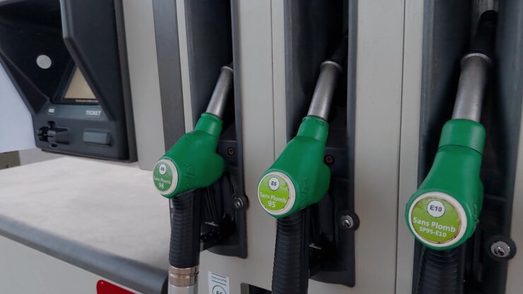 Multiple fuel pump nozzles at French petrol station, showing fuel type options