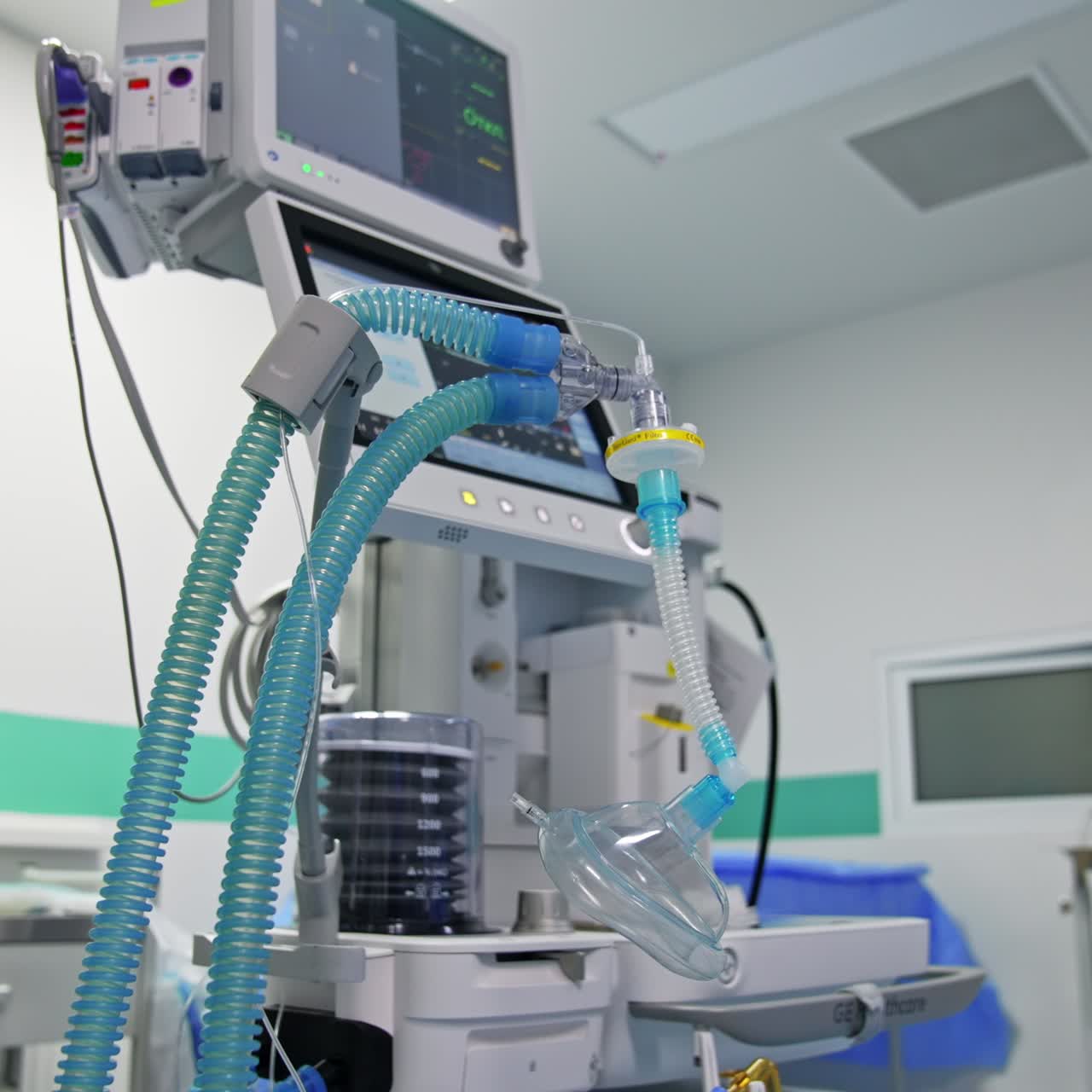 Blue tubes with oxygen mask for a patient breathing during operation. Modern surgery equipment at backdrop
