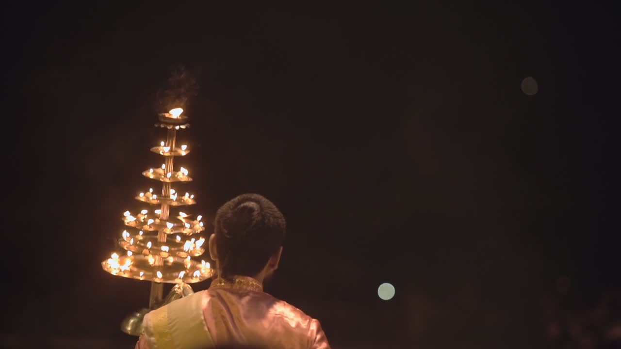A Priest Carrying Out A Ganga Aarti Hindu Ceremony By Moving The Lamp Up And Down In Dashashwamedh Ghat, Varanasi, Uttar Pradesh, India. -medium shot