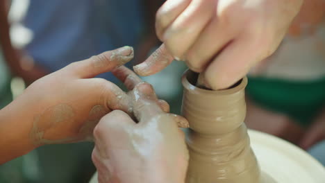 the master potter teaches the child how to make pots concept - transfer of experience training 4k 10