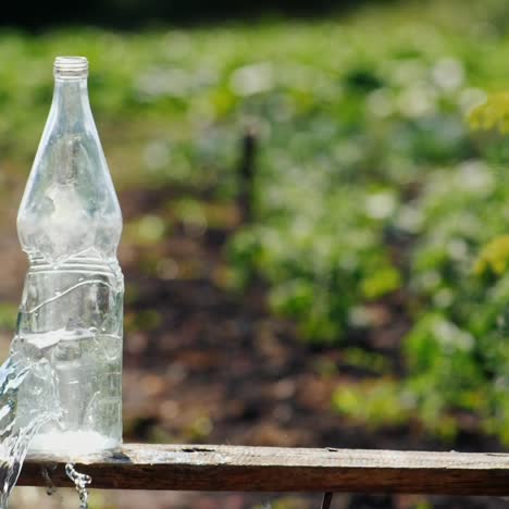 a bullet from an air rifle falls into a glass bottle of water