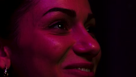 woman laughing while watching the big screen in a cinema