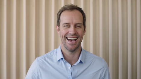 portrait-of-relaxed-caucasian-businessman-laughing-happy-looking-at-camera-confident-male-entrepreneur-enjoying-success