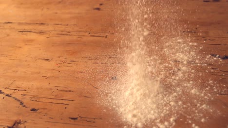 flour sprinkled onto wooden work surface