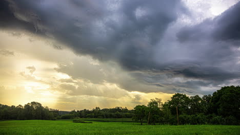 timelapse of ominous clouds forming with sunlight rays over the green landscape in europe