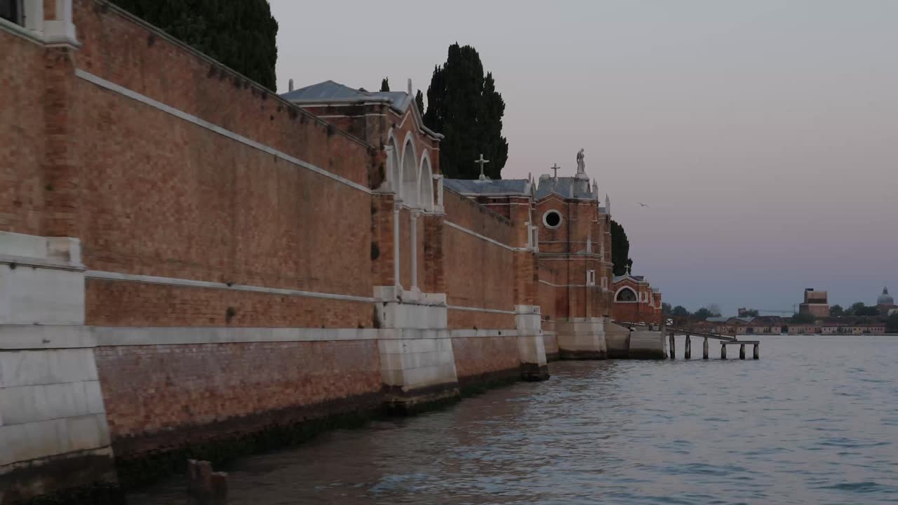 hermosos edificios de la ciudad de venecia después de la puesta del sol desde un barco en movimiento