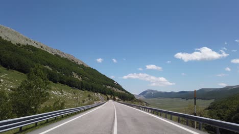 moving view (car, motorbike or bicycle) of a mountain landscape