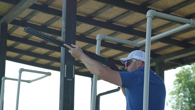 Sportsman shoots from a double-barreled shotgun, A sports field for a shooting test is shooting at flying skeet