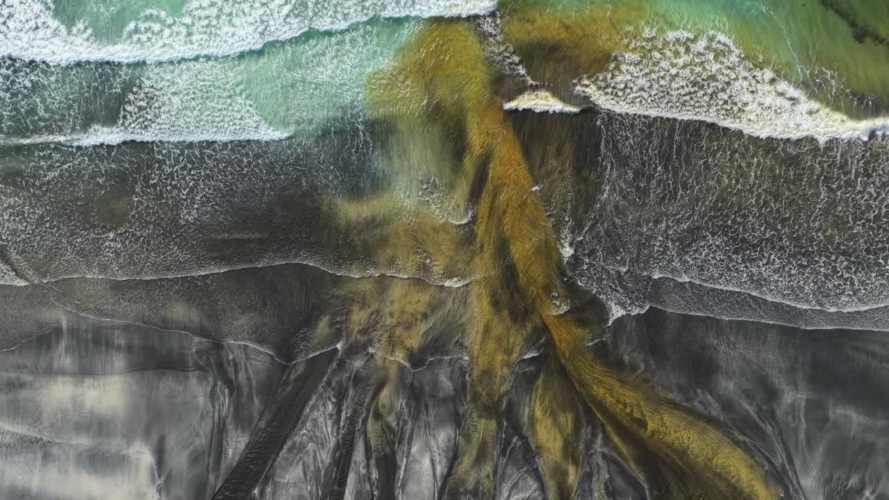 Vista aérea superior de rio desaguando no oceano na praia de Talisker Bay