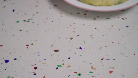 Hands-remove-whole-Tortilla-Espanola-or-Spanish-Omelette-from-frame,-Closeup