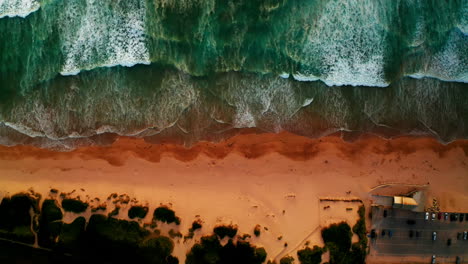 aerial drone shot over the sandy beach in newquay, cornwall, united kingdom