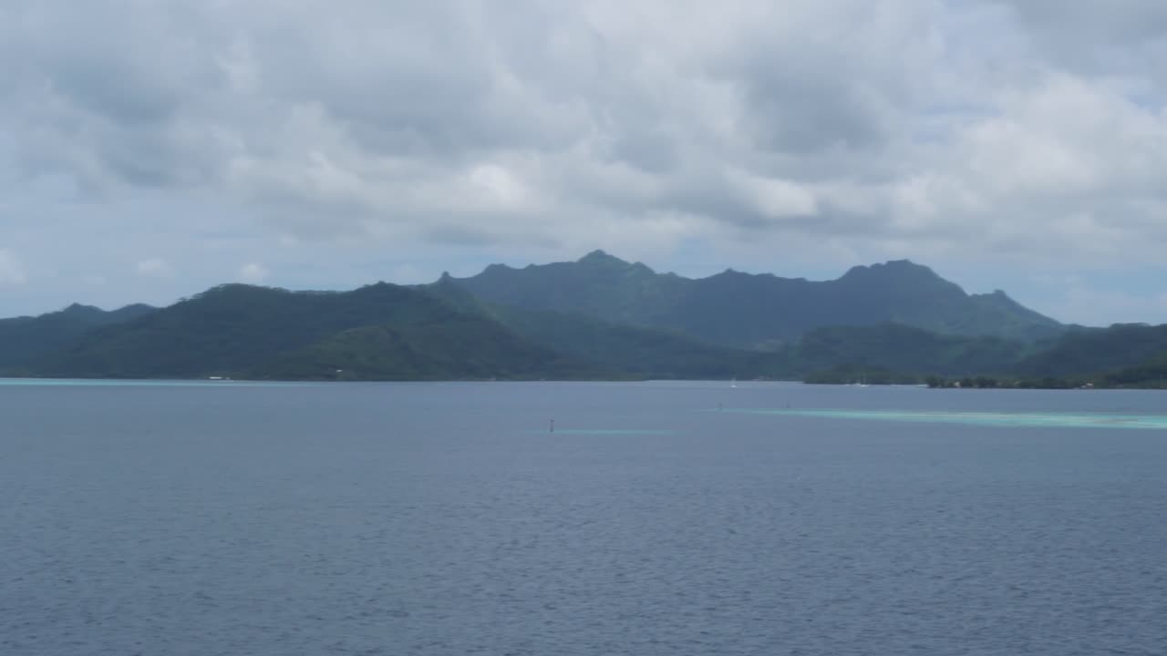 Serene Tropical Island Landscape with Lush Mountains and Calm Ocean