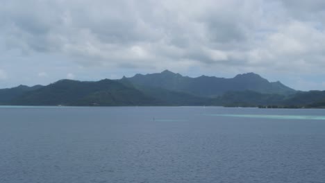 serene tropical island landscape with lush mountains and calm ocean