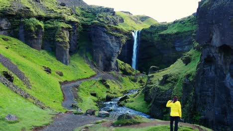 woman standing in front of a waterfall