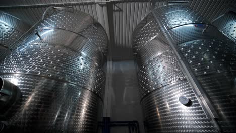 large steel barrels for wine fermentation. wine production plant. steel wine distilling tanks.